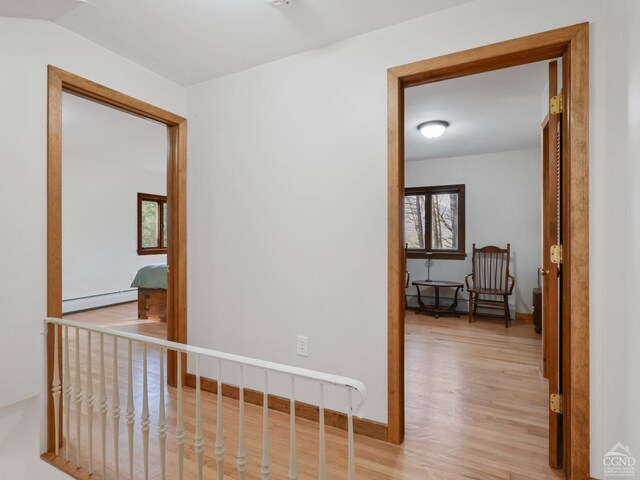 hallway featuring light hardwood / wood-style flooring and a baseboard heating unit