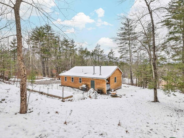 view of snow covered rear of property