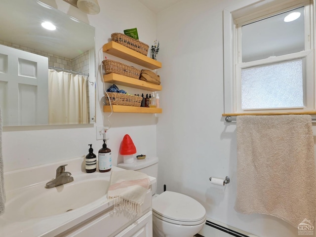 bathroom with a shower with curtain, vanity, toilet, and a baseboard heating unit