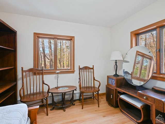 sitting room featuring light wood-type flooring and a baseboard radiator