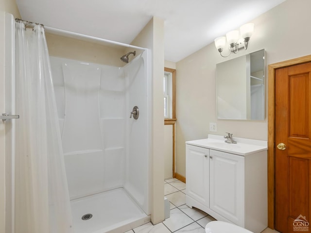 bathroom featuring tile patterned flooring, a shower with curtain, and vanity