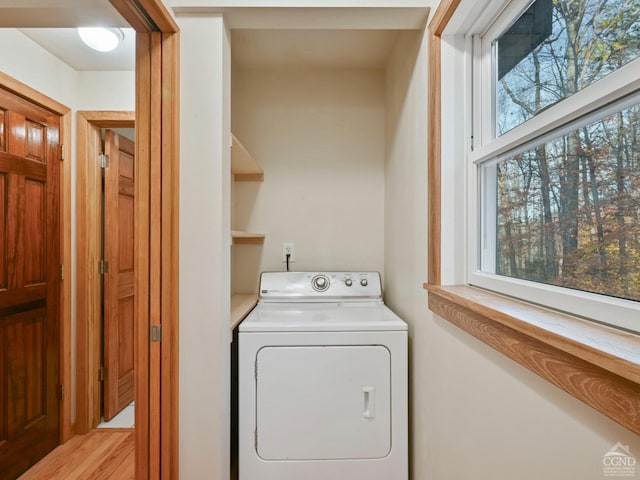 washroom with a healthy amount of sunlight and washer / dryer