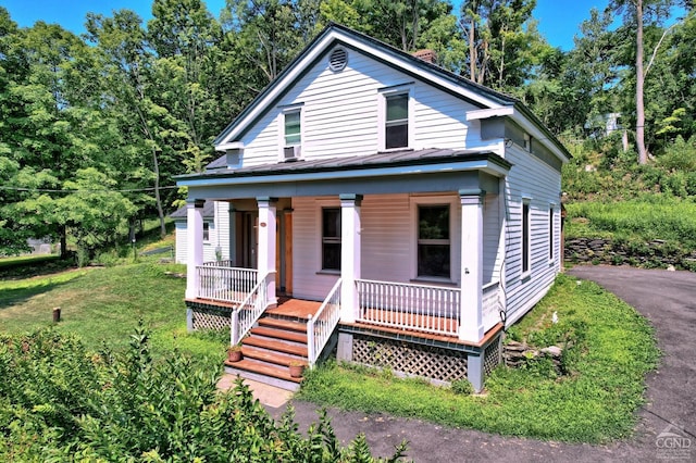 view of front of home featuring a front yard and a porch