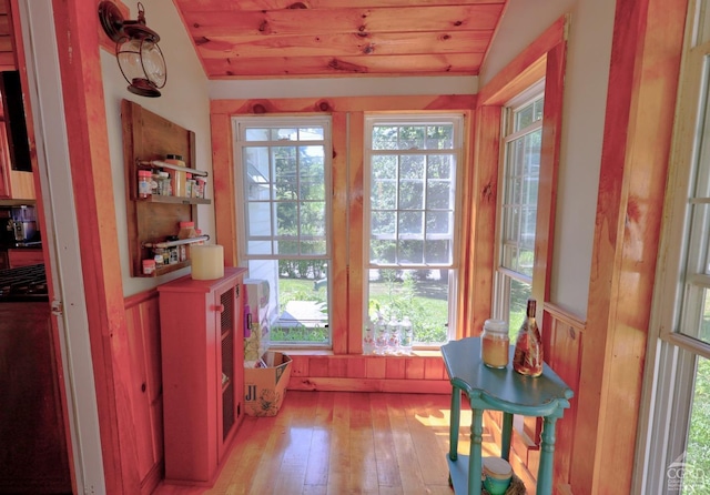 entryway featuring light hardwood / wood-style floors, vaulted ceiling, and wooden ceiling