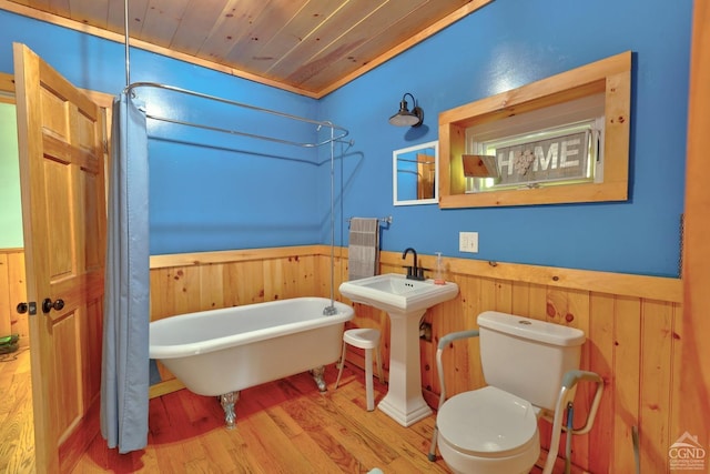 bathroom featuring hardwood / wood-style flooring, toilet, wood walls, and wood ceiling