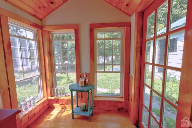 sunroom with plenty of natural light and vaulted ceiling