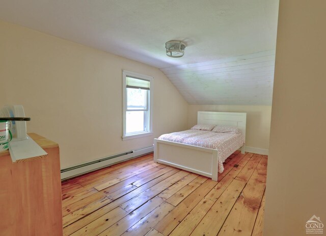 bedroom with light wood-type flooring, a baseboard radiator, and lofted ceiling