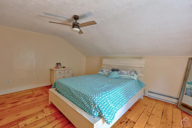 bedroom featuring a textured ceiling, baseboard heating, ceiling fan, light hardwood / wood-style floors, and lofted ceiling