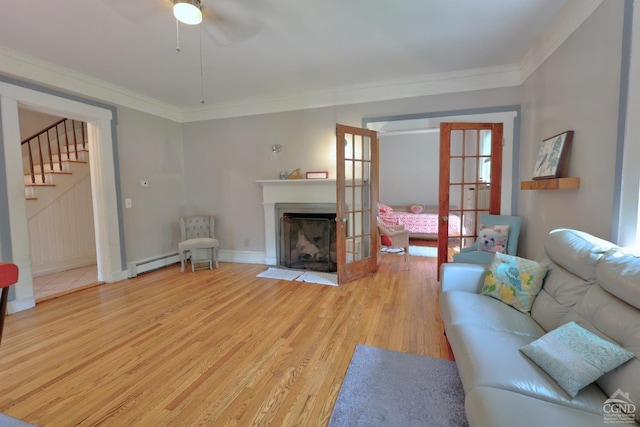 living room featuring ceiling fan, ornamental molding, light hardwood / wood-style flooring, and a baseboard radiator