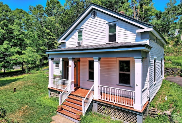 view of front of home with covered porch and a front yard