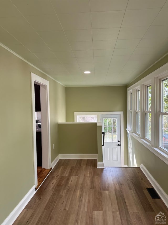 entryway with crown molding and hardwood / wood-style floors