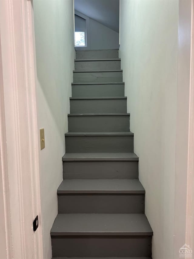 stairway with lofted ceiling