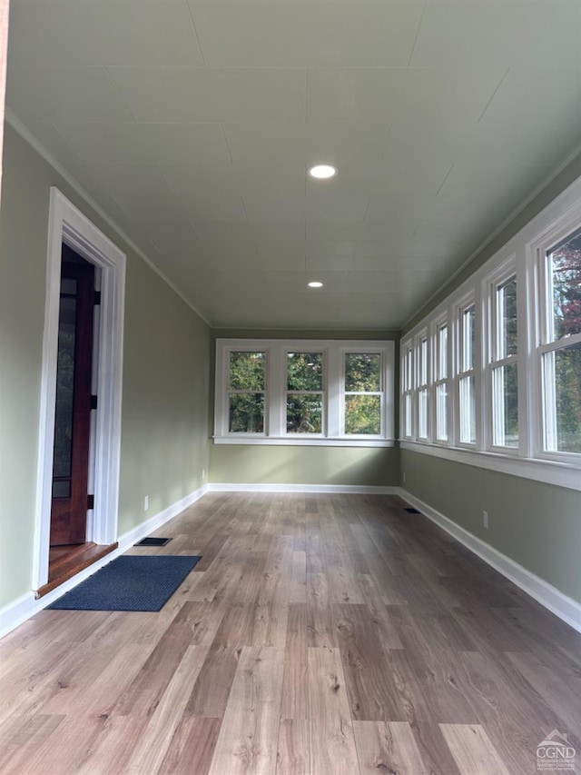 interior space featuring plenty of natural light, light hardwood / wood-style floors, and ornamental molding