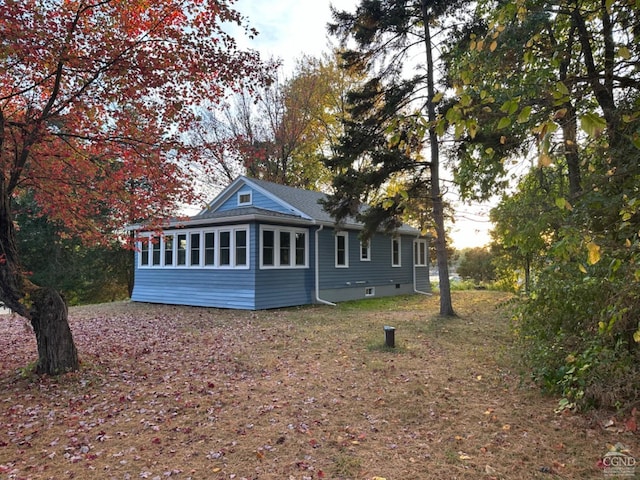 rear view of house featuring a sunroom