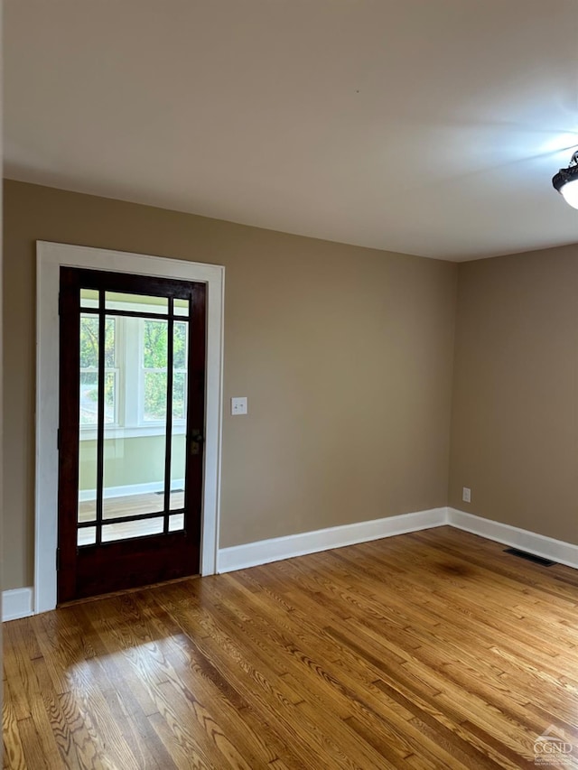 empty room with wood-type flooring