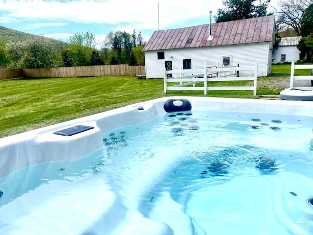 view of pool featuring a lawn