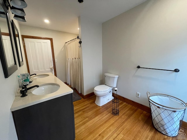 bathroom featuring hardwood / wood-style floors, vanity, and toilet