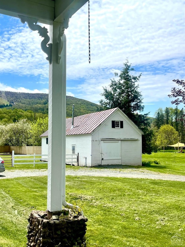 view of home's exterior with an outbuilding and a yard