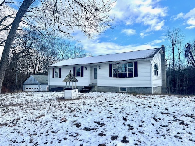 view of front of house with an outdoor structure and a garage