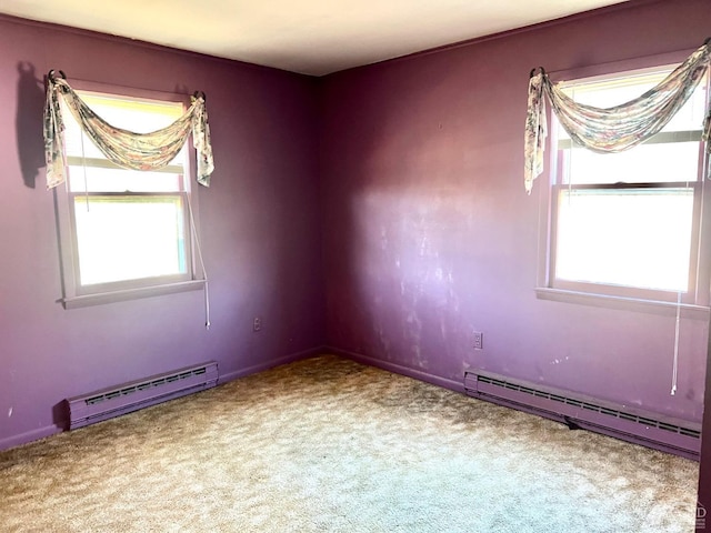 carpeted spare room with a baseboard radiator