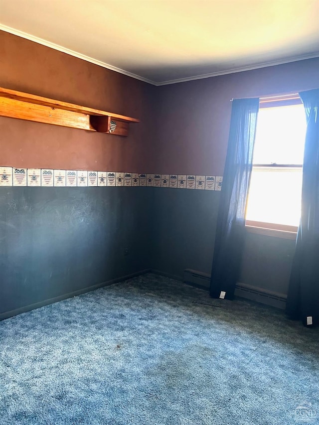 carpeted spare room featuring crown molding and a baseboard radiator