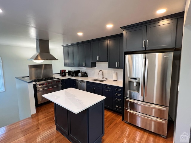 kitchen featuring sink, light wood-type flooring, stainless steel appliances, and range hood