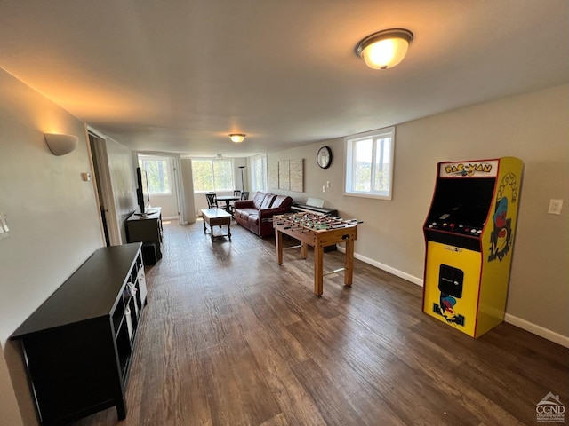 recreation room with a wealth of natural light and dark wood-type flooring