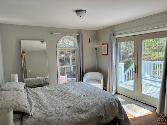 bedroom featuring access to outside, hardwood / wood-style floors, and french doors