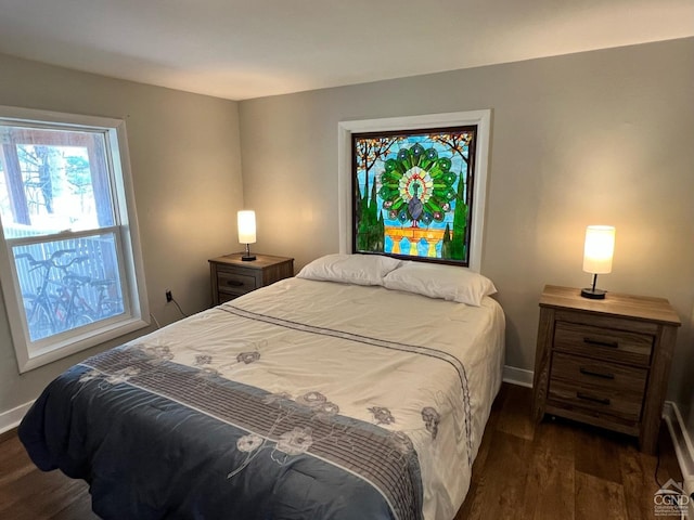 bedroom with dark wood-type flooring