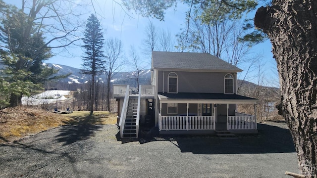 view of front of home with covered porch and a mountain view