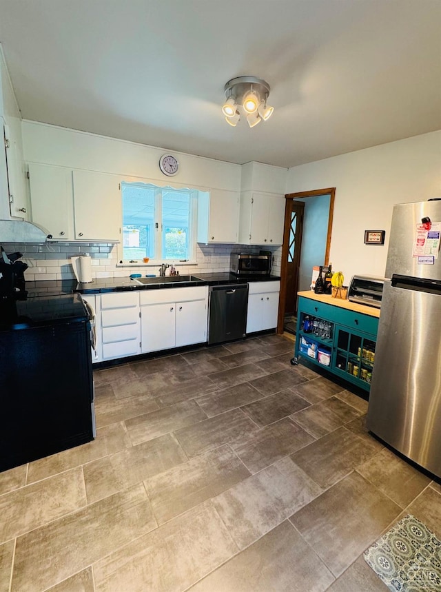 kitchen with tasteful backsplash, white cabinetry, sink, and black appliances