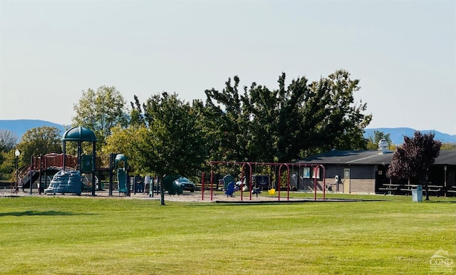 view of play area featuring a mountain view and a yard