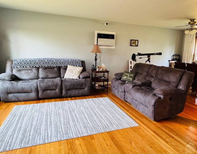 living room featuring ceiling fan and wood-type flooring