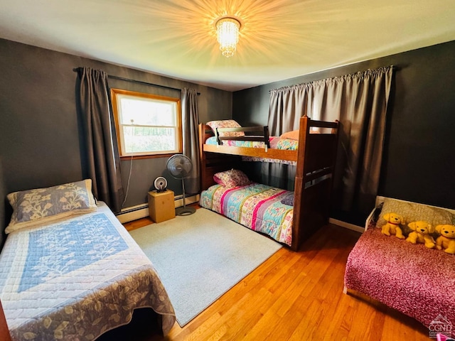 bedroom with hardwood / wood-style flooring and a baseboard radiator