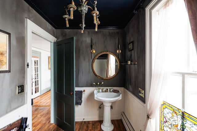 bathroom with a baseboard heating unit and wood finished floors