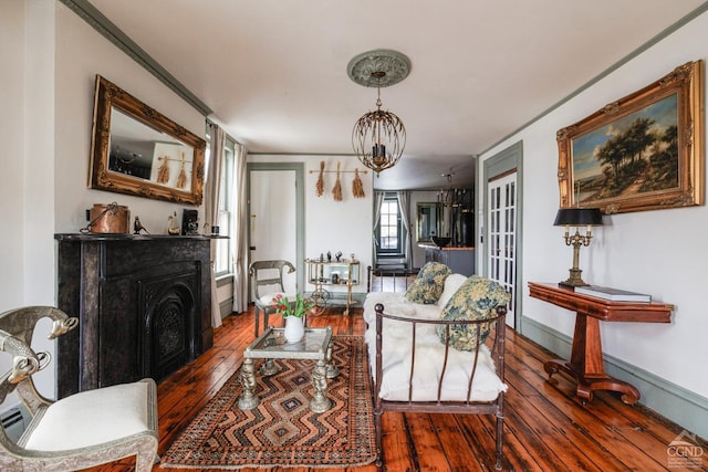 living area with wood-type flooring, a fireplace, and baseboards