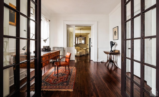 hallway with ornamental molding, french doors, and hardwood / wood-style floors