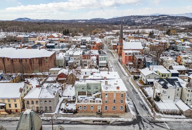 snowy aerial view featuring a mountain view