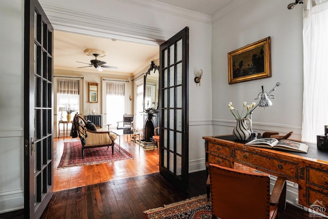 office space featuring hardwood / wood-style flooring, a ceiling fan, crown molding, and french doors