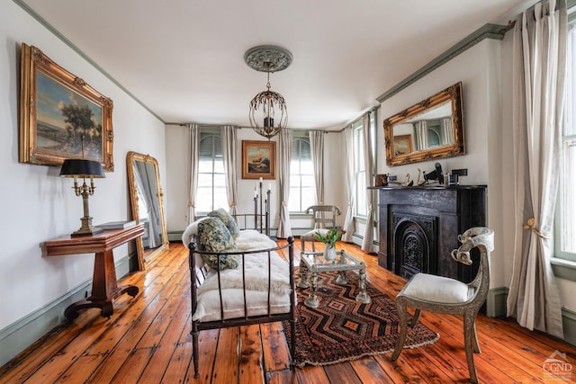 sitting room featuring wood-type flooring and a fireplace