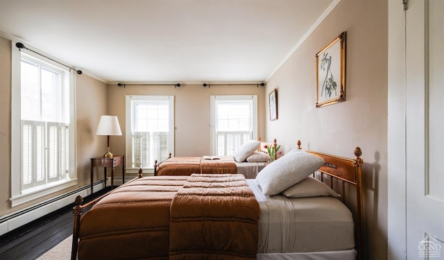 bedroom featuring a baseboard radiator, crown molding, and wood finished floors