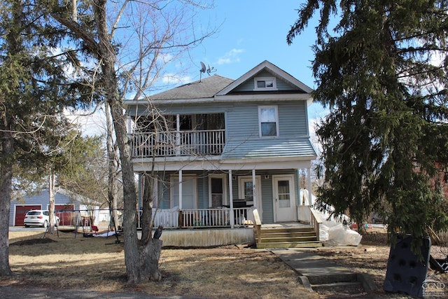 view of front of property with a shingled roof, covered porch, and a balcony