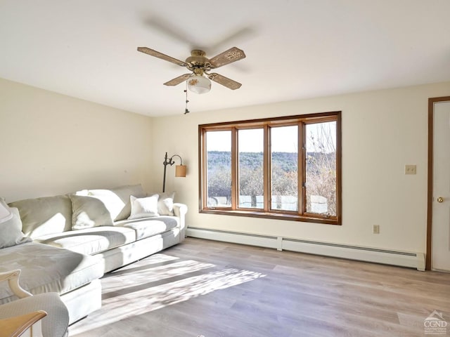 living room with light hardwood / wood-style flooring, ceiling fan, and a baseboard heating unit