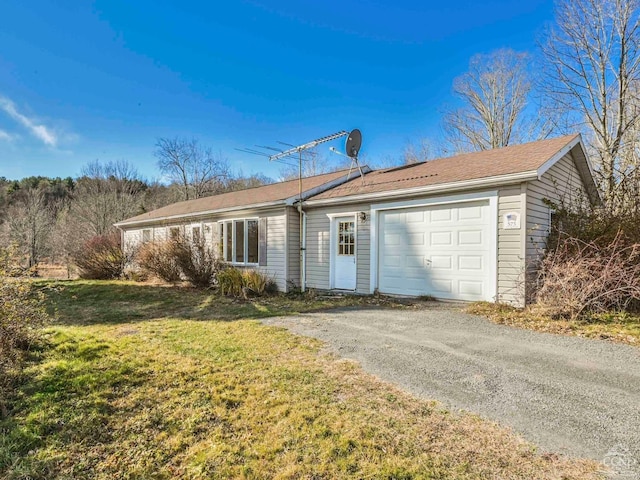 exterior space with a garage and a front lawn