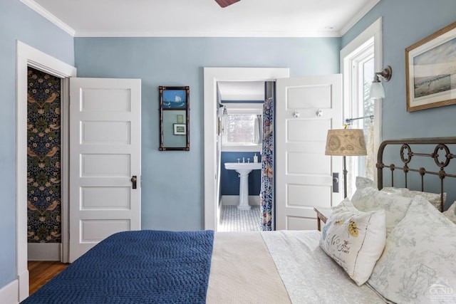 bedroom featuring baseboards, ornamental molding, and wood finished floors