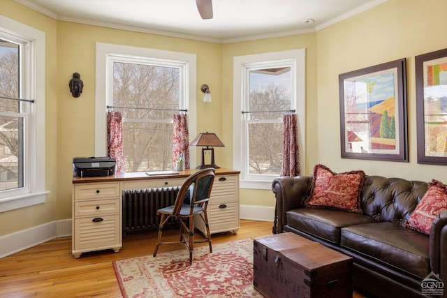 office space featuring light wood-style floors, baseboards, ornamental molding, and radiator heating unit