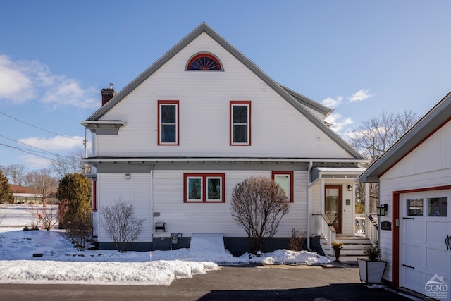 view of front of house with a garage and a chimney