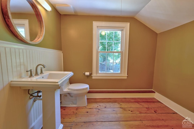 bathroom with hardwood / wood-style floors, lofted ceiling, and toilet