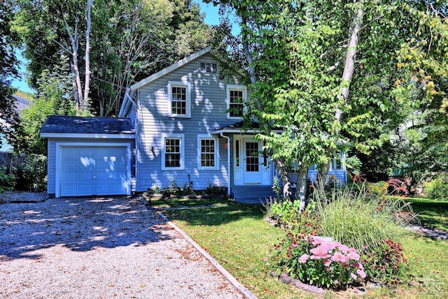 view of front of house with a porch, a garage, and a front lawn