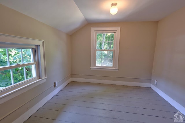 additional living space with lofted ceiling and light hardwood / wood-style flooring